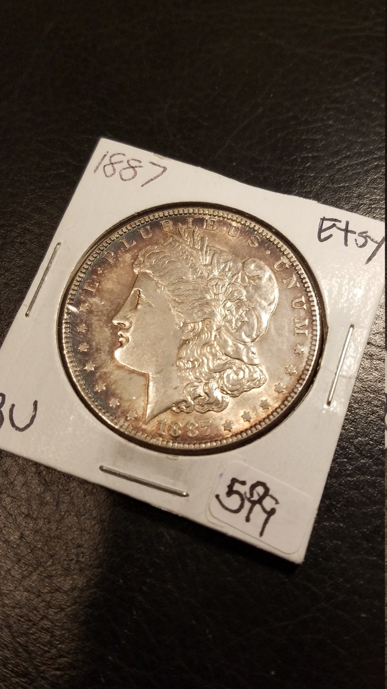 1887 Morgan Silver Dollar BU - nice toning! . Lot#599 Regular 105 - usacoinsstore